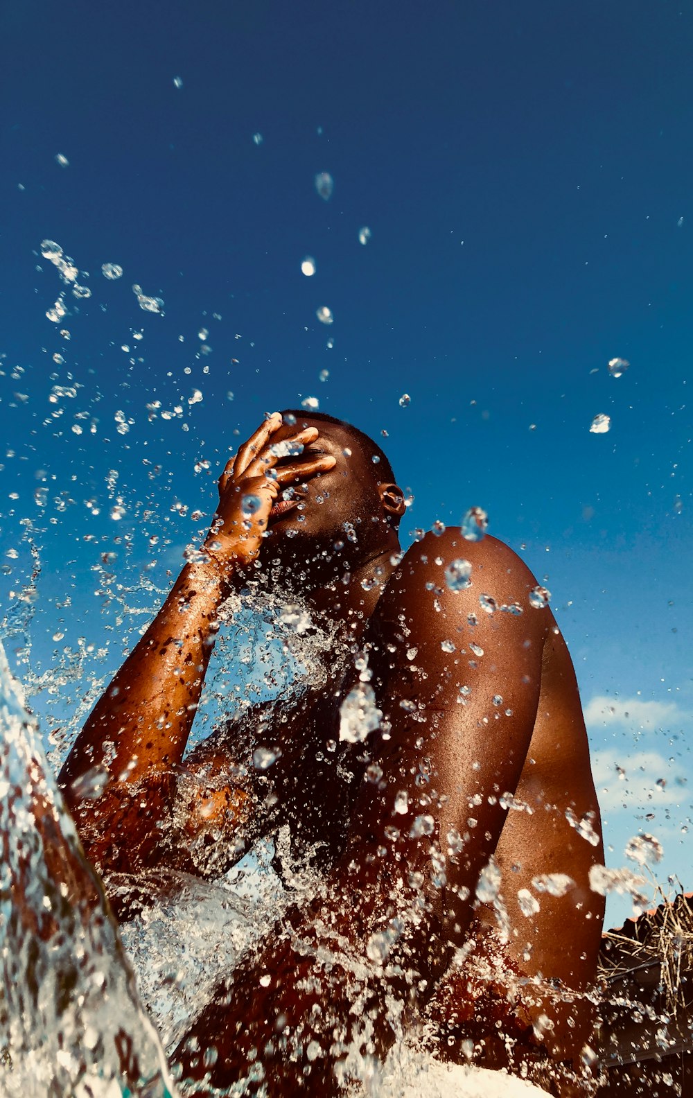 a man laying on top of a surfboard in the ocean