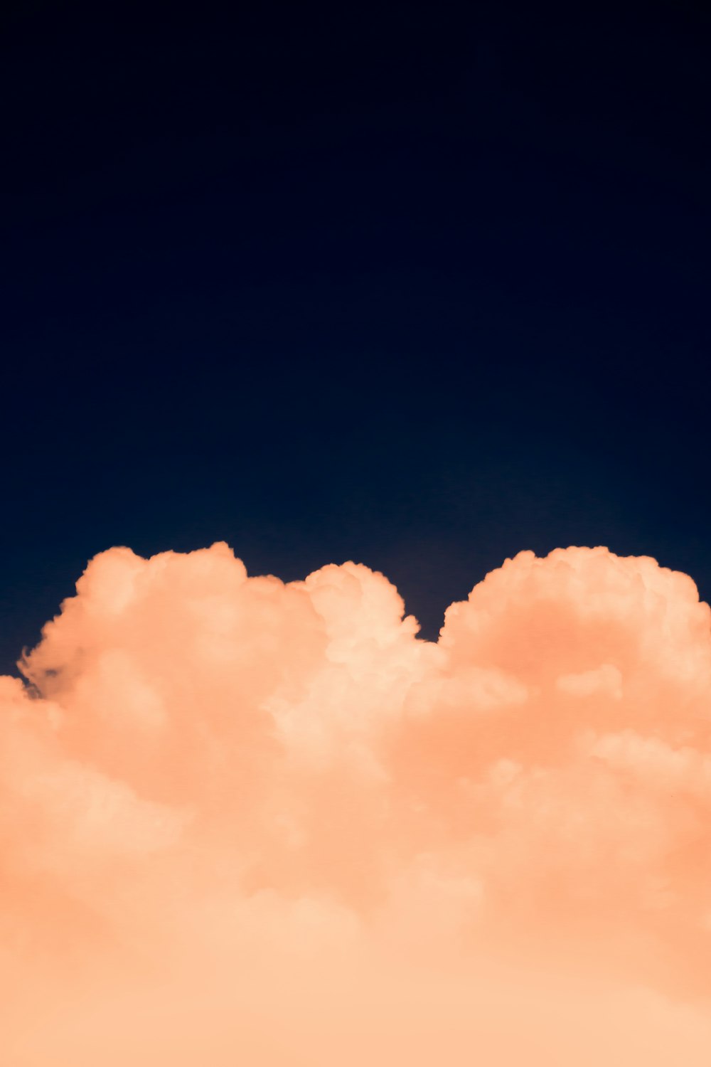 a plane flying in the sky with a lot of clouds