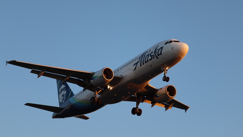 a large jetliner flying through a blue sky