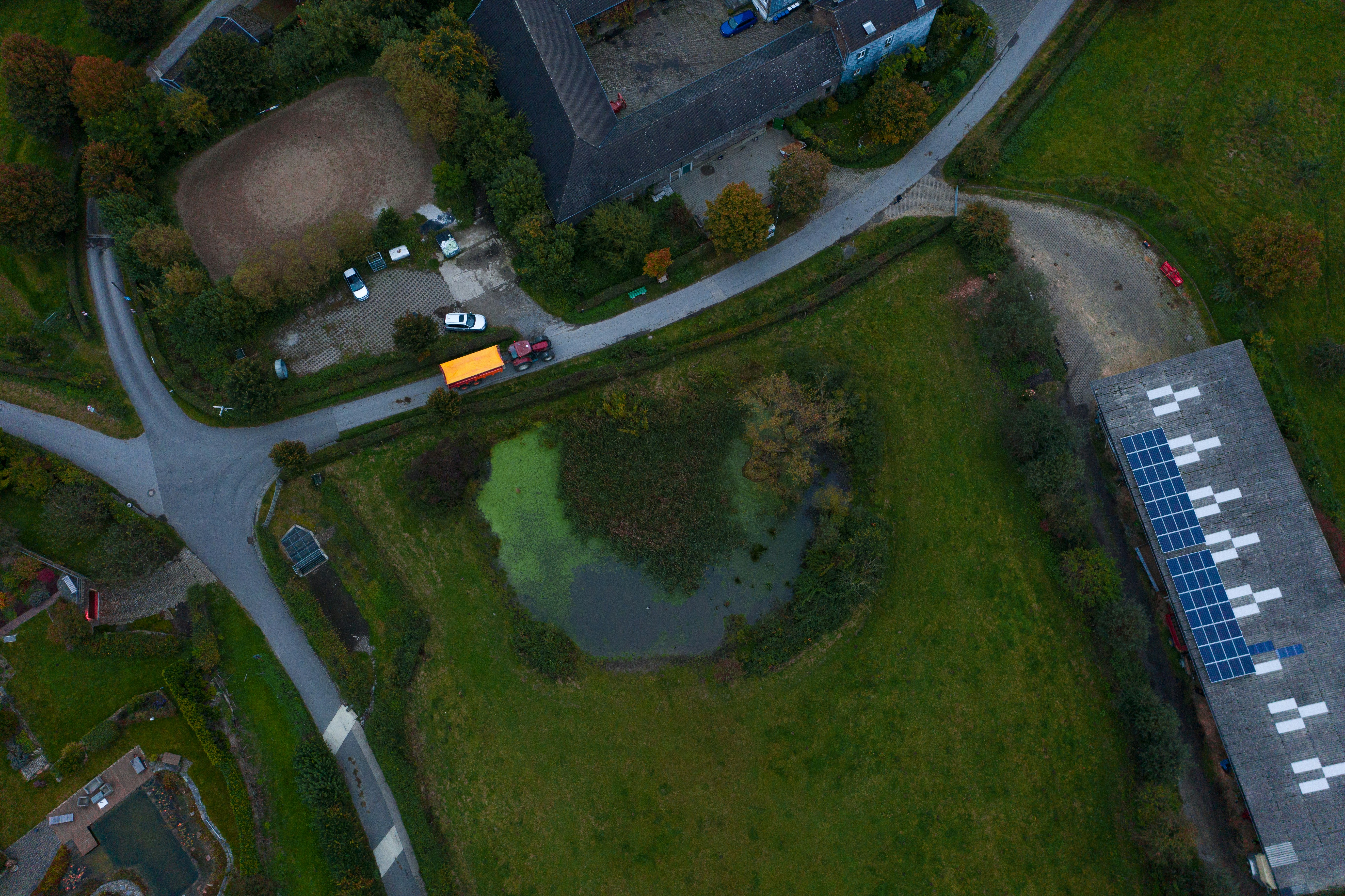 an aerial view of a parking lot with a solar panel on the roof
