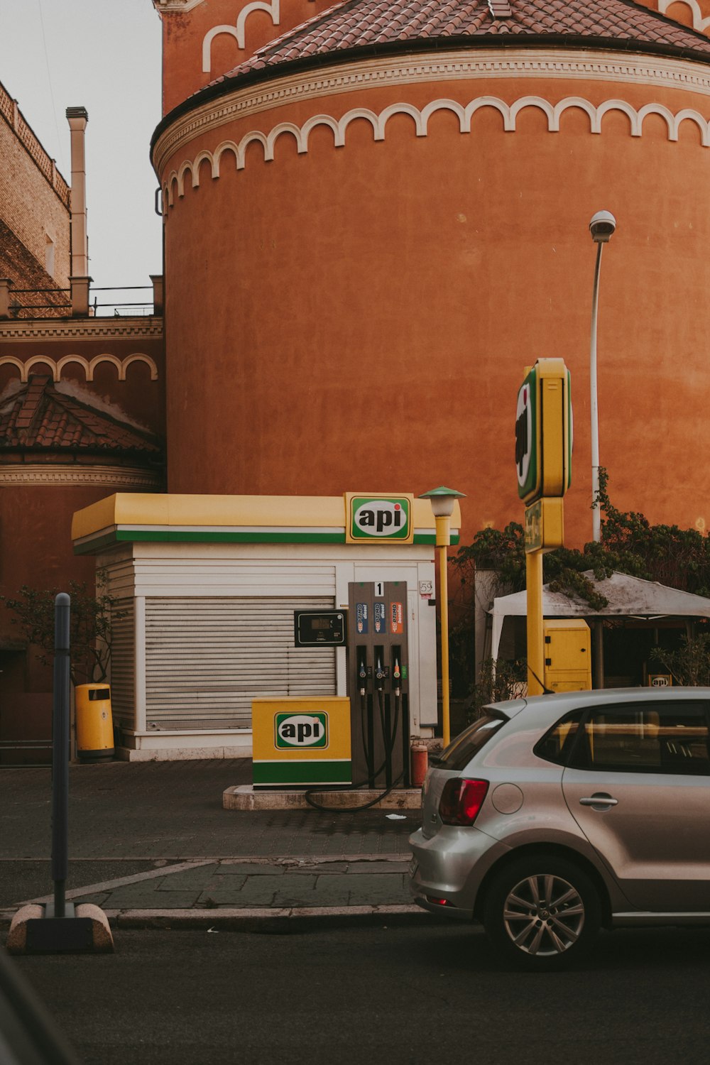 a car parked in front of a gas station