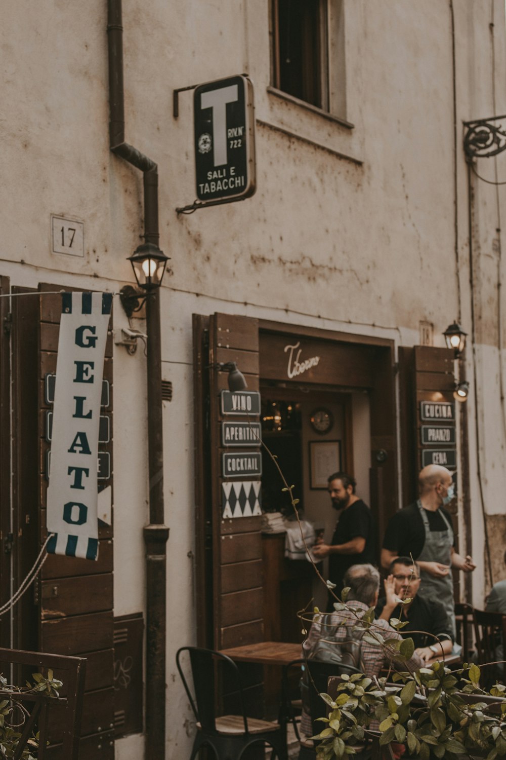 a group of people sitting outside of a restaurant