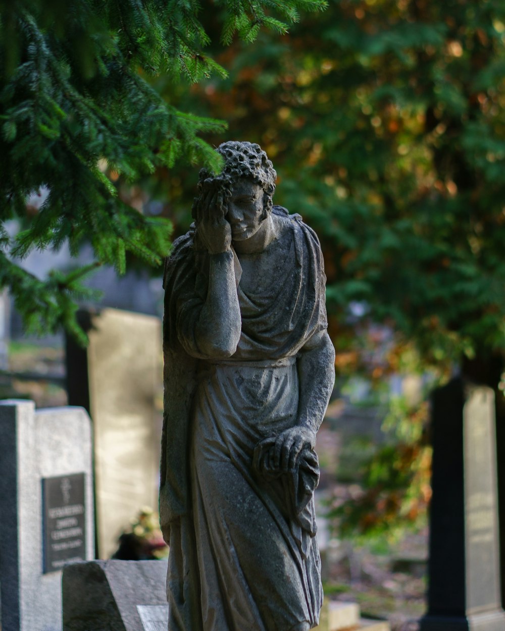 a statue of a man holding his head in his hands