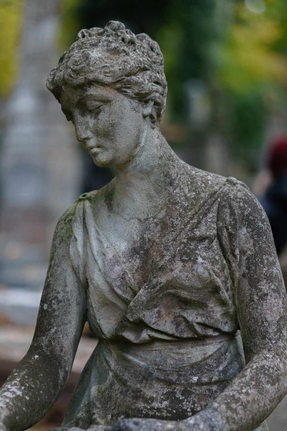 a statue of a woman sitting on a bench