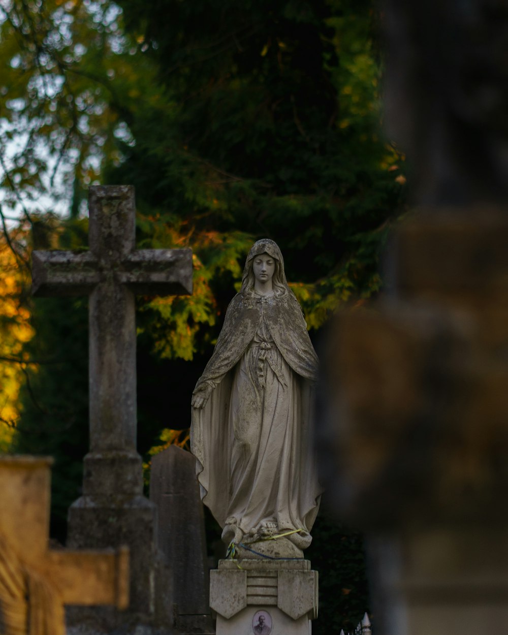 a statue of a woman in a cemetery