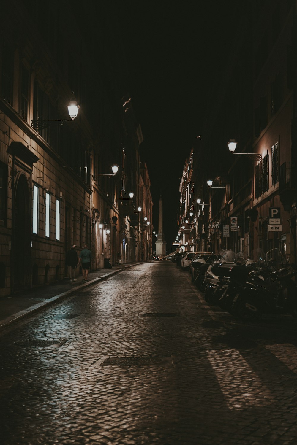 a cobblestone street at night in a european city