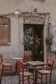 a restaurant with tables and chairs outside of it