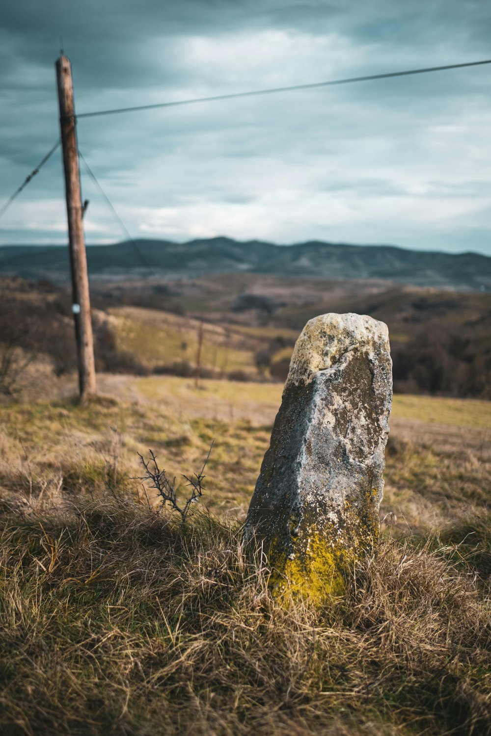 a large rock sitting in the middle of a field