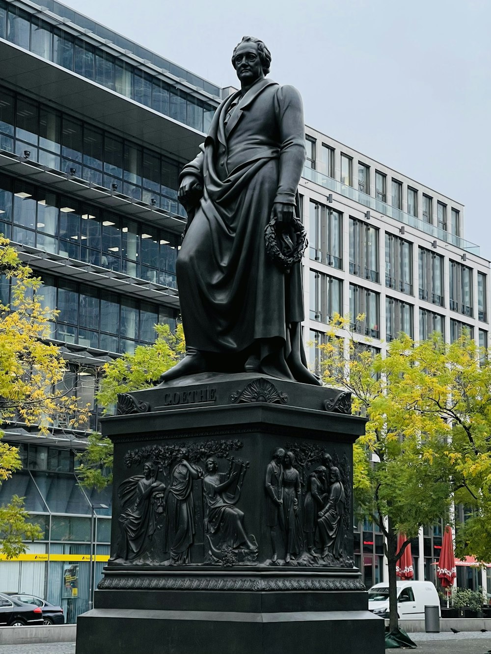 a statue of a man with a hat and a cane