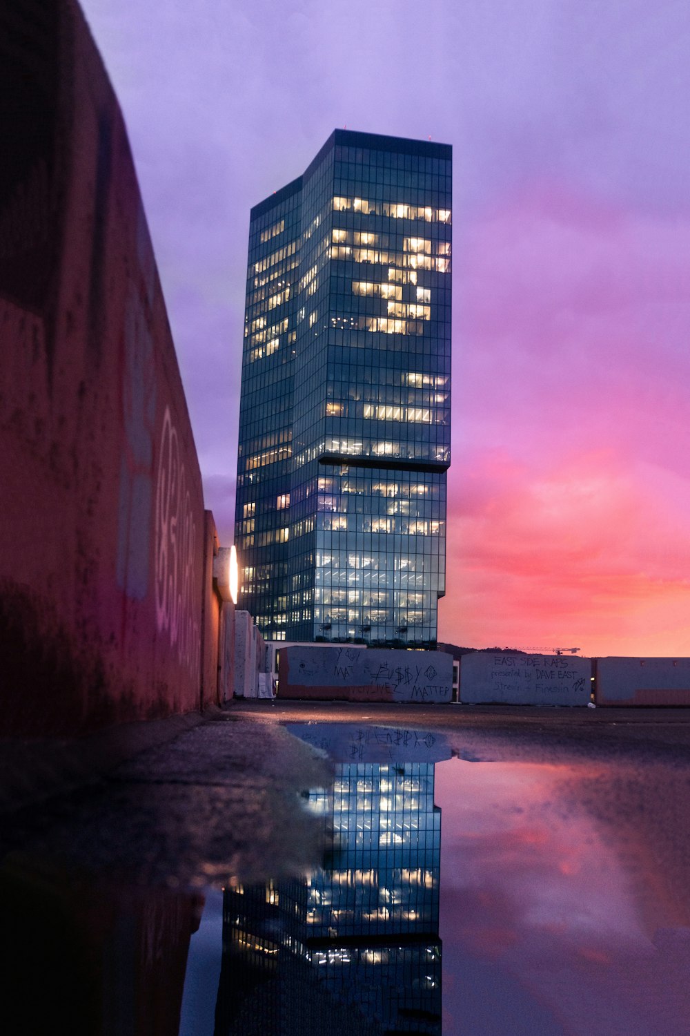 a very tall building sitting next to a body of water