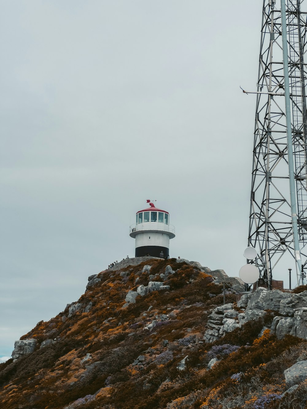 a lighthouse on top of a rocky hill