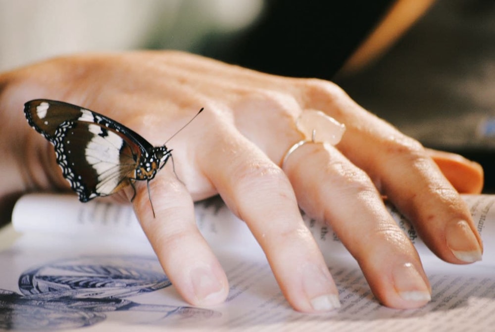 a woman's hand with a butterfly on it