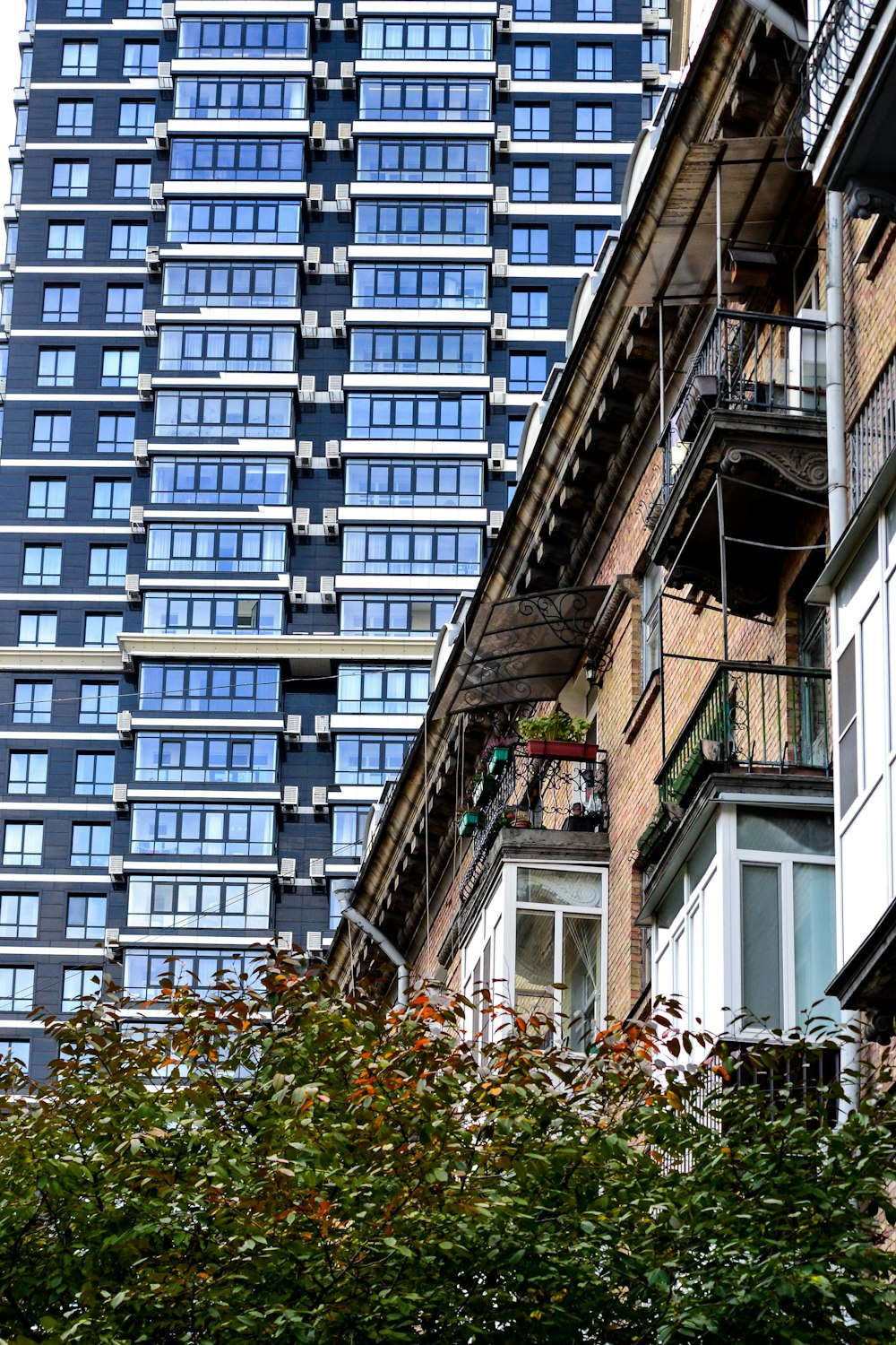 a tall building with lots of windows and balconies