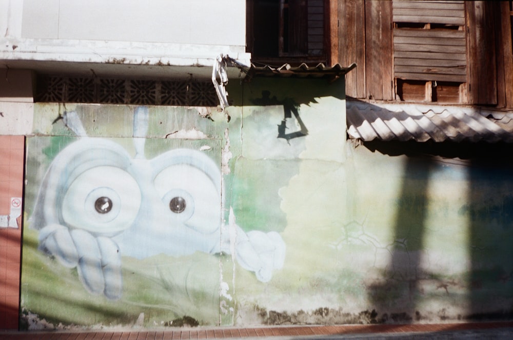 a mural of an elephant painted on the side of a building