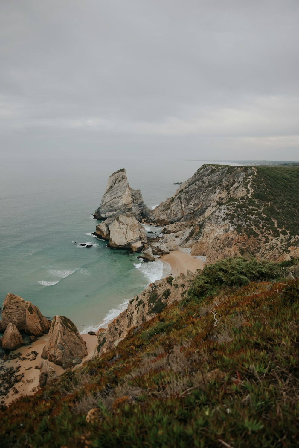 a view of the ocean from the top of a hill