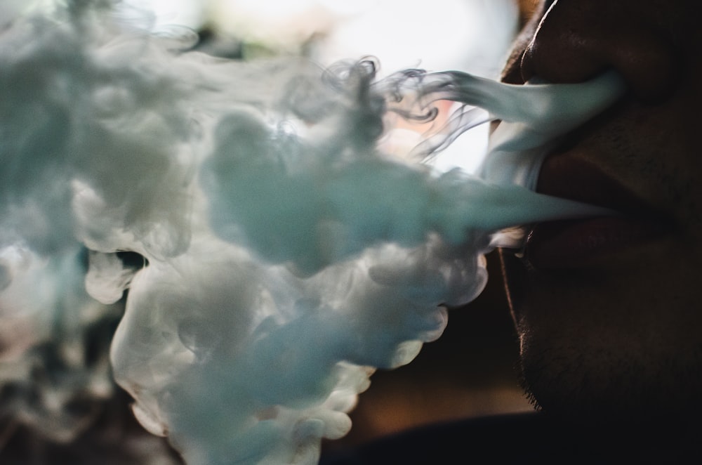 a close up of a person smoking a cigarette