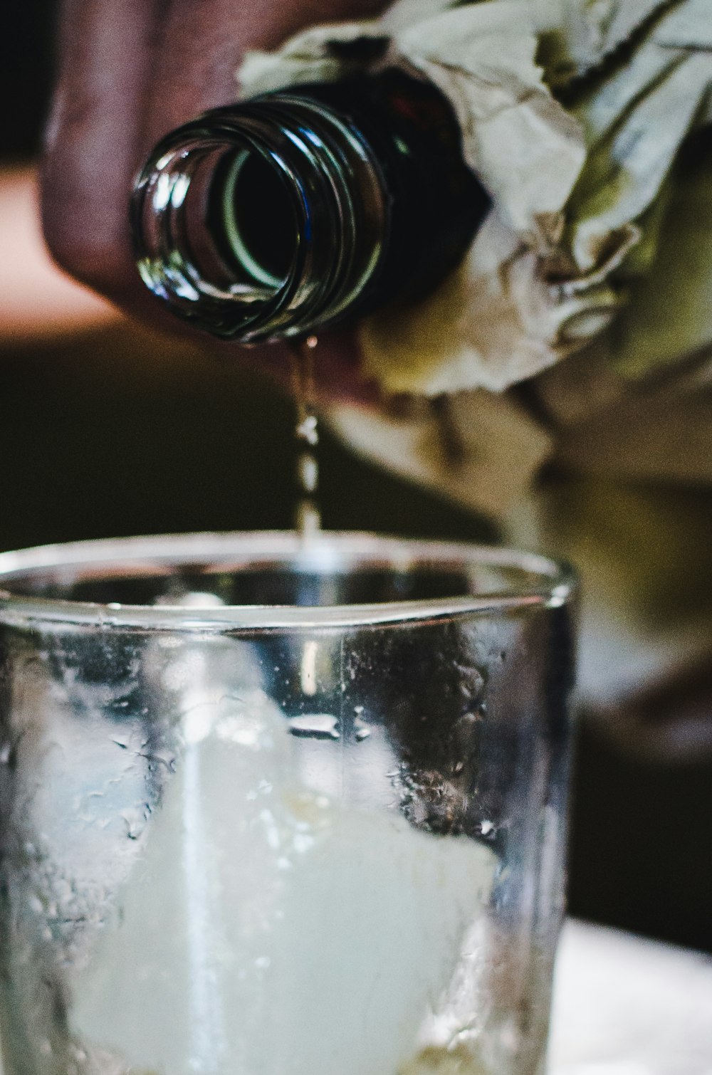 a glass filled with ice sitting on top of a table