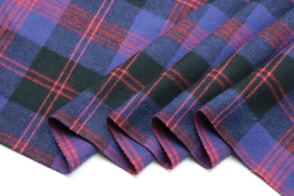 a close up of a purple and black plaid fabric