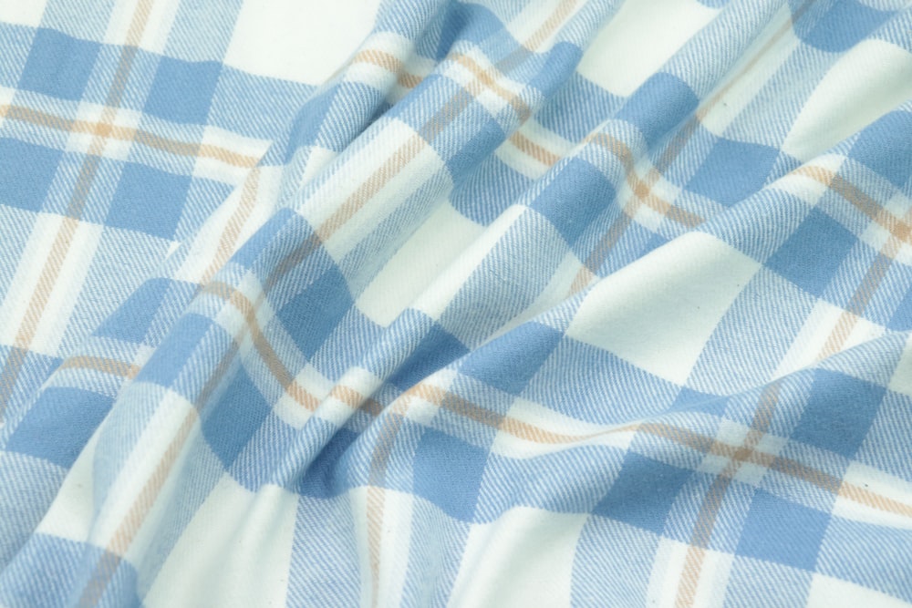 a close up of a blue and white plaid fabric