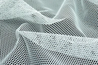 a close up of a black and white mesh
