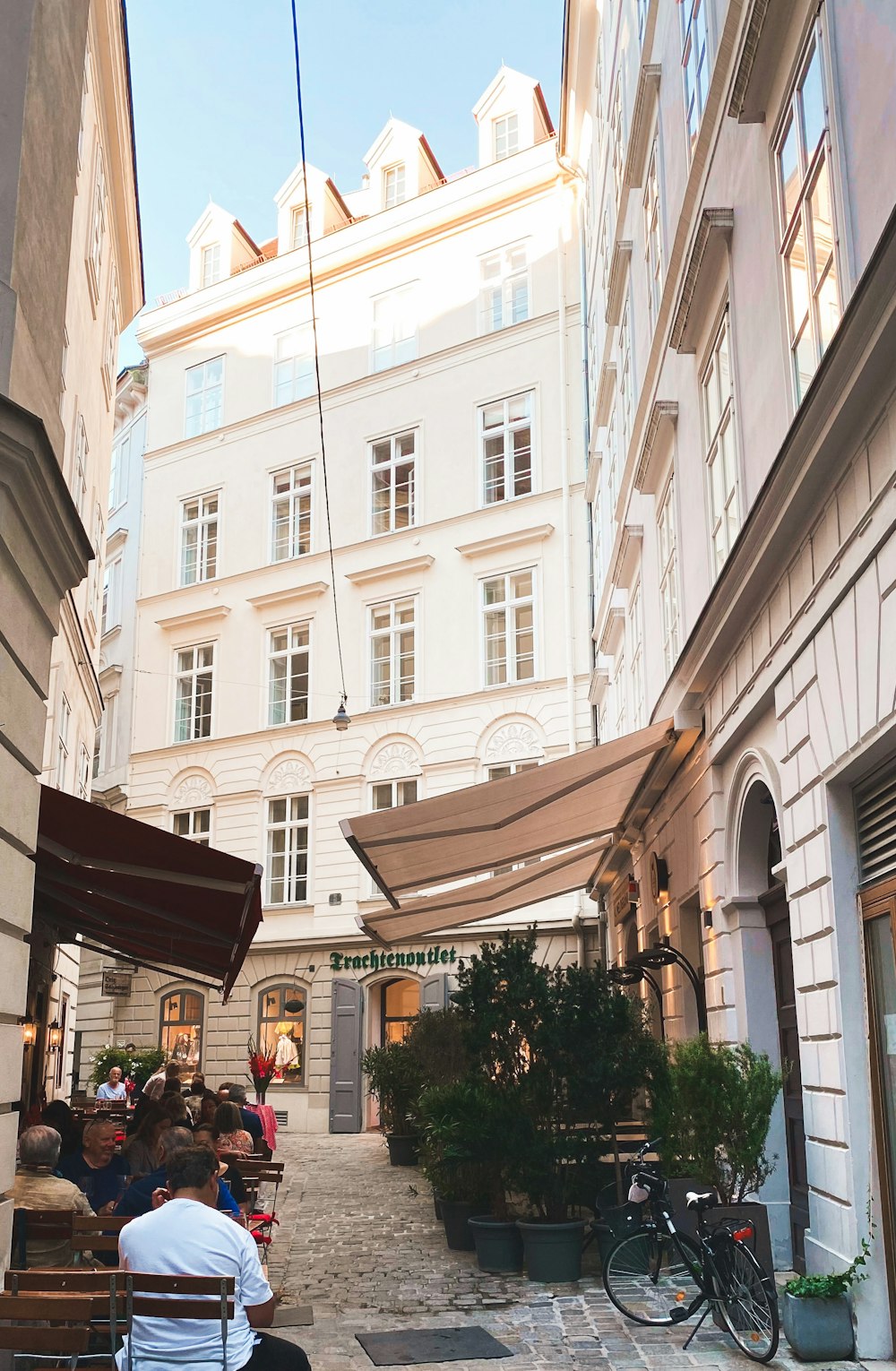 a couple of people sitting on a bench in front of a building