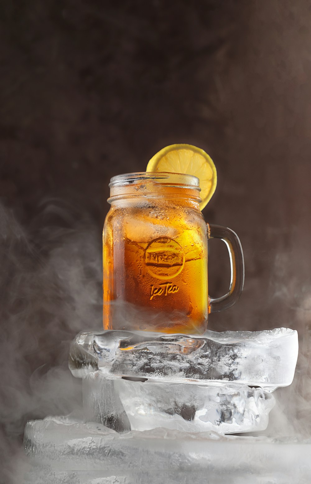 a mason jar with a lemon on top of ice