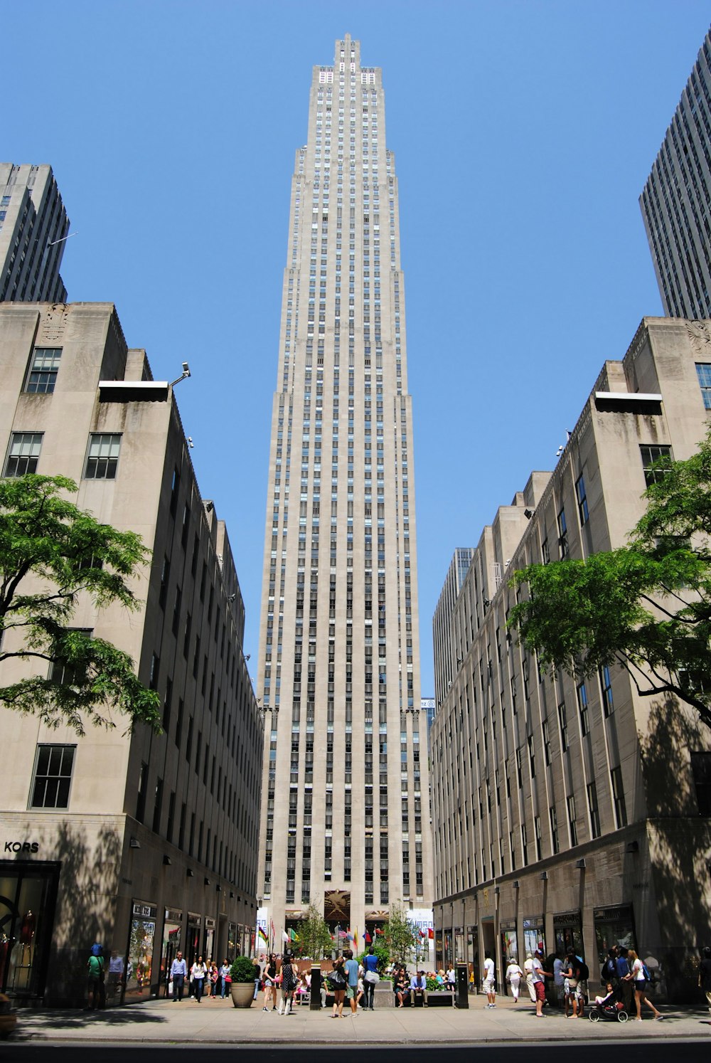 a very tall building towering over a city filled with tall buildings