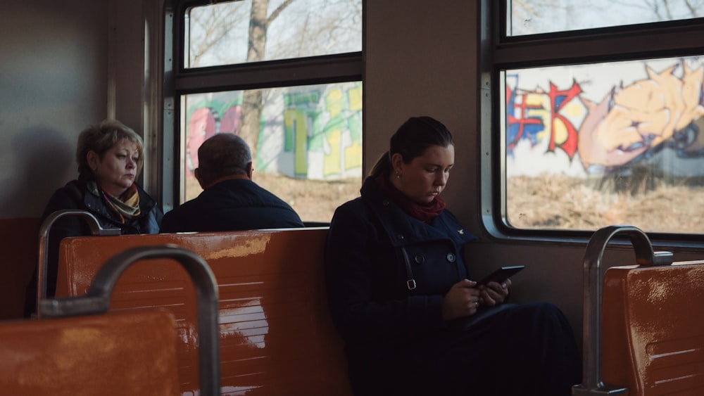 a group of people sitting in a chair in front of a window