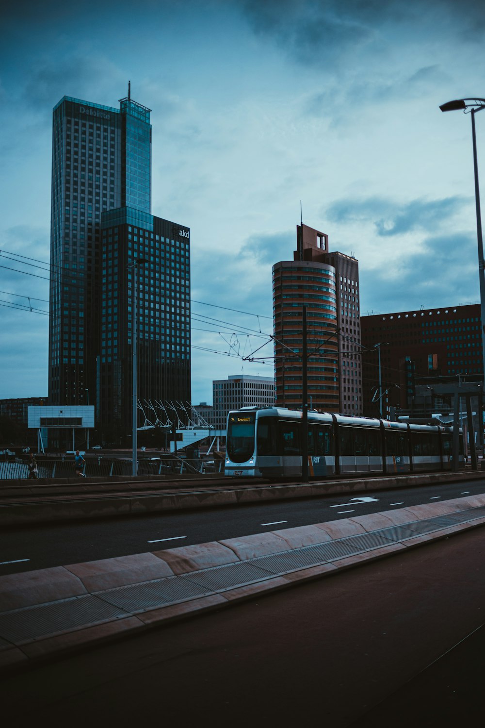 a train on a track in front of some tall buildings