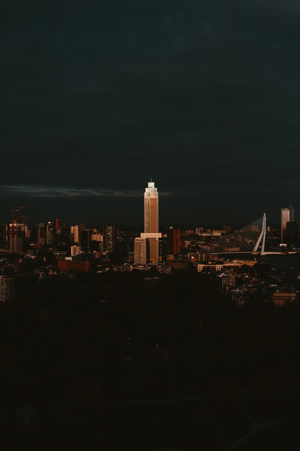 a view of a city at night from a hill