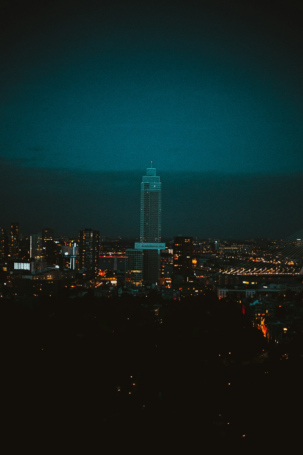 a view of a city at night from the top of a hill