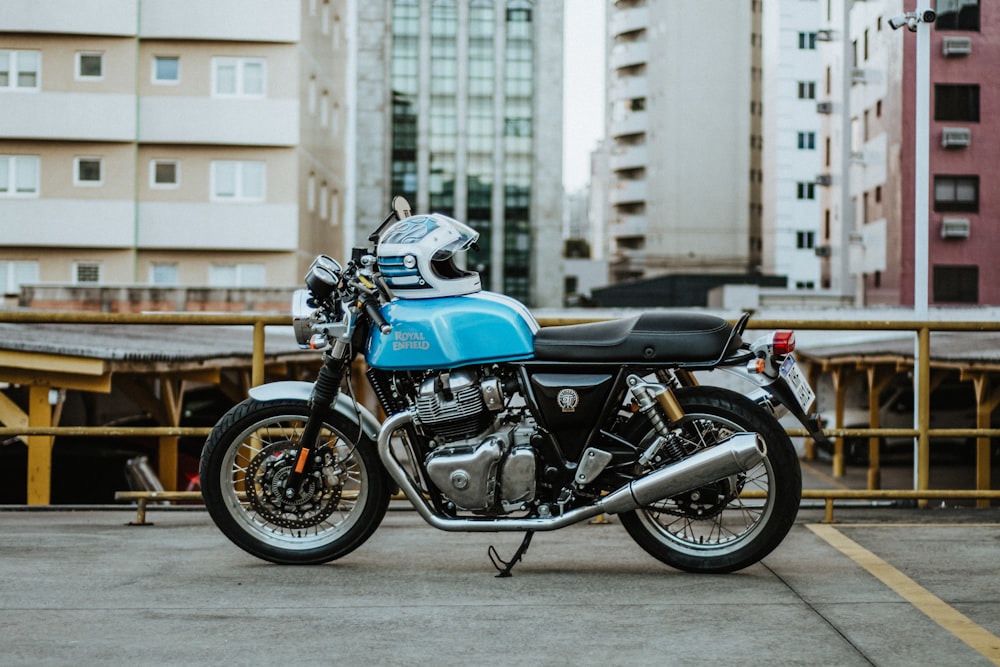 a blue motorcycle parked in a parking lot