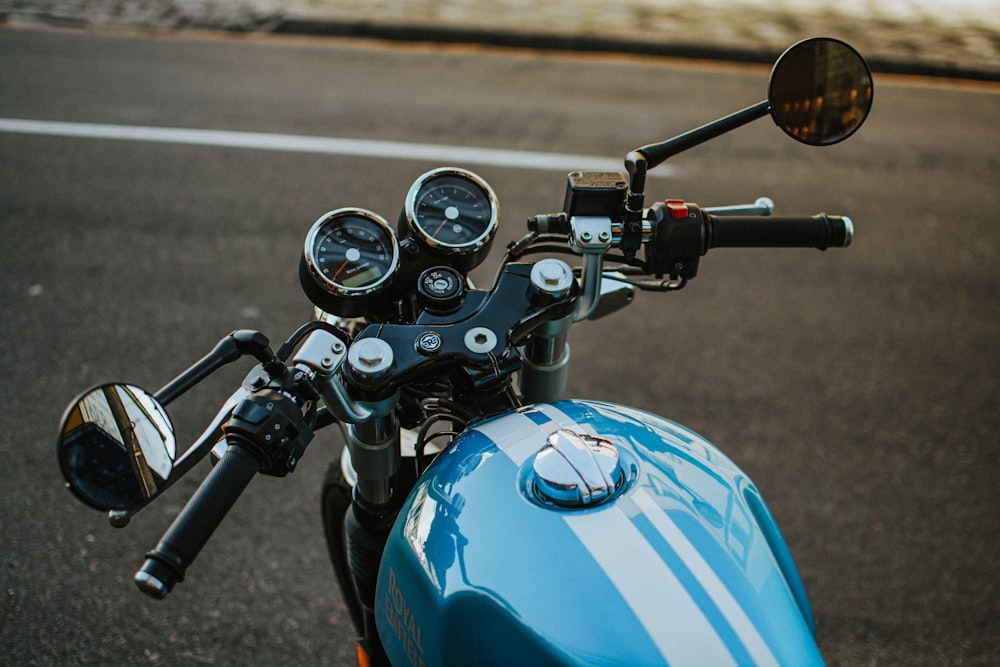 a blue motorcycle parked on the side of the road