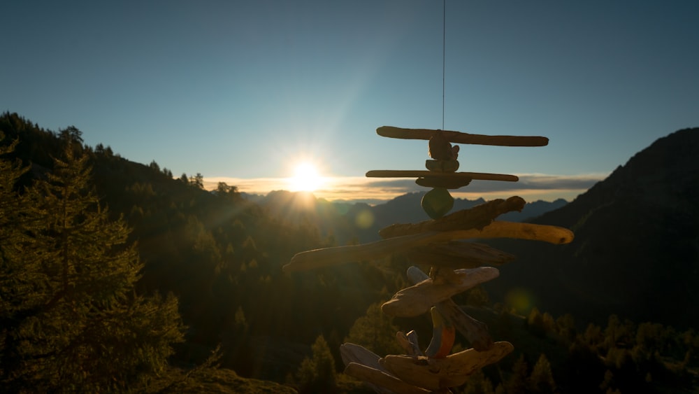 a wind chime with a sunset in the background