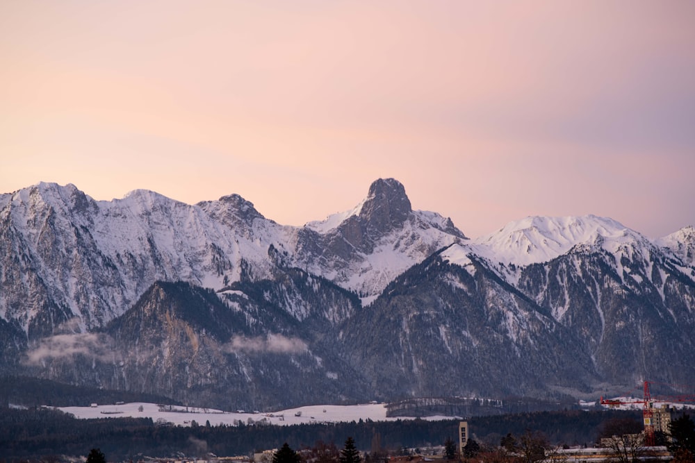 a view of a mountain range with snow on it