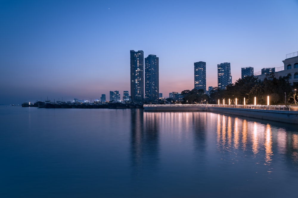 a body of water with buildings in the background