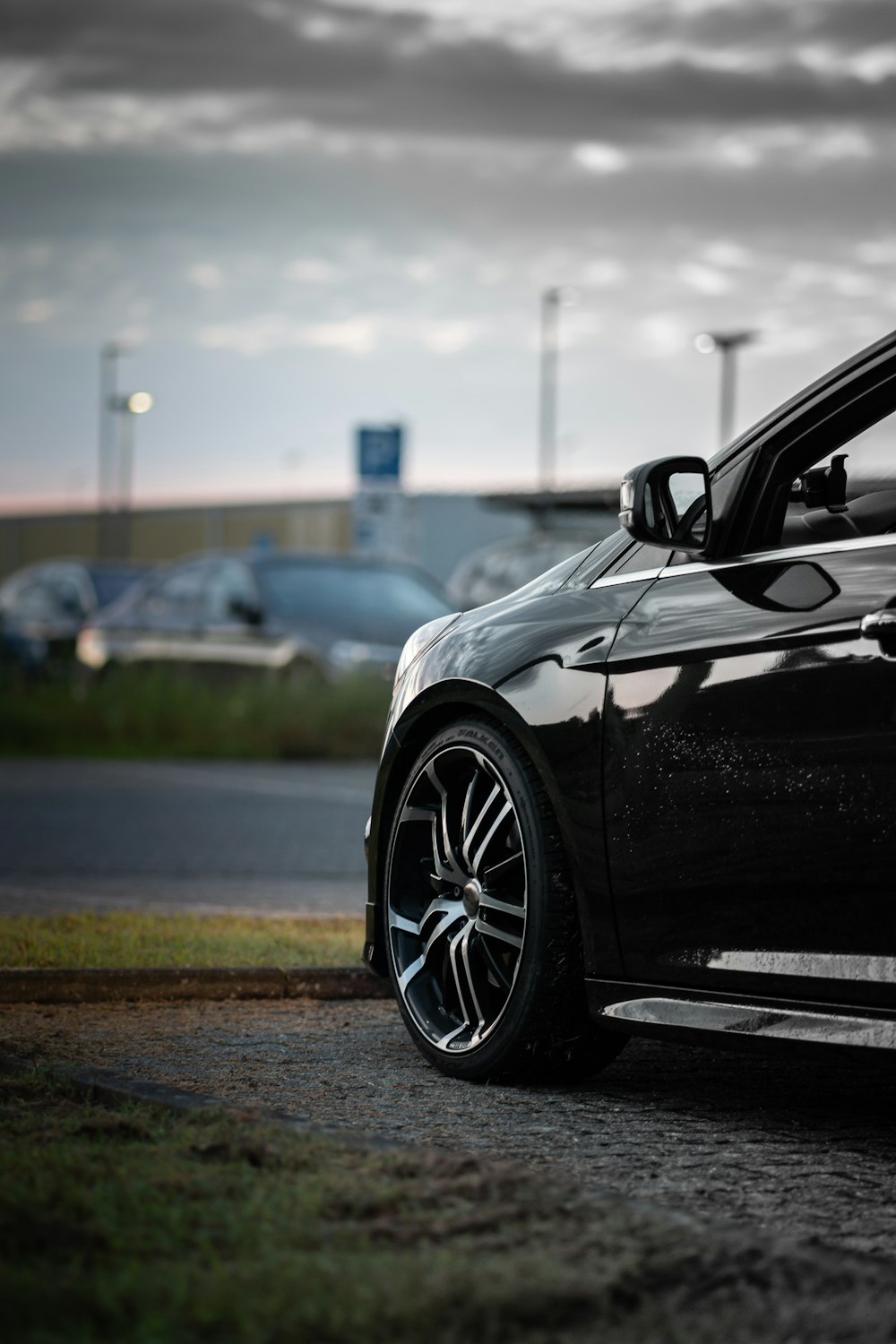 a black car parked on the side of a road