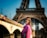a woman standing in front of the eiffel tower
