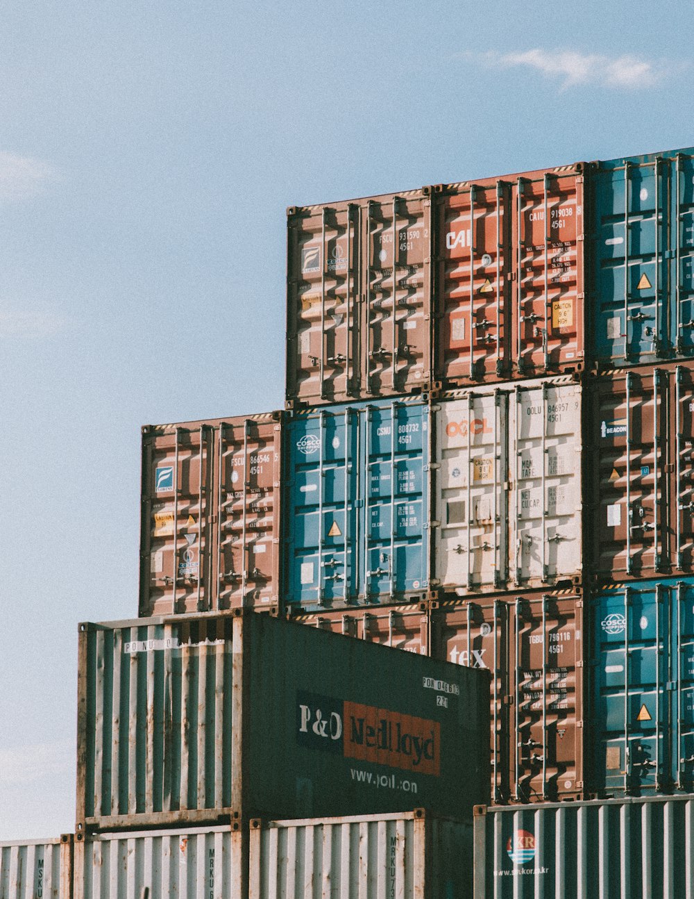 a large stack of shipping containers stacked on top of each other