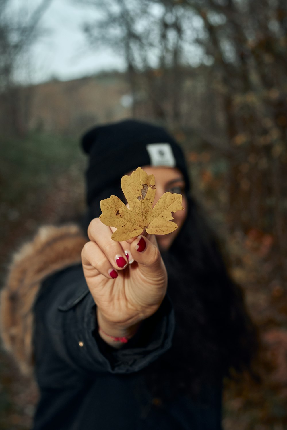 a woman holding a leaf in her hand