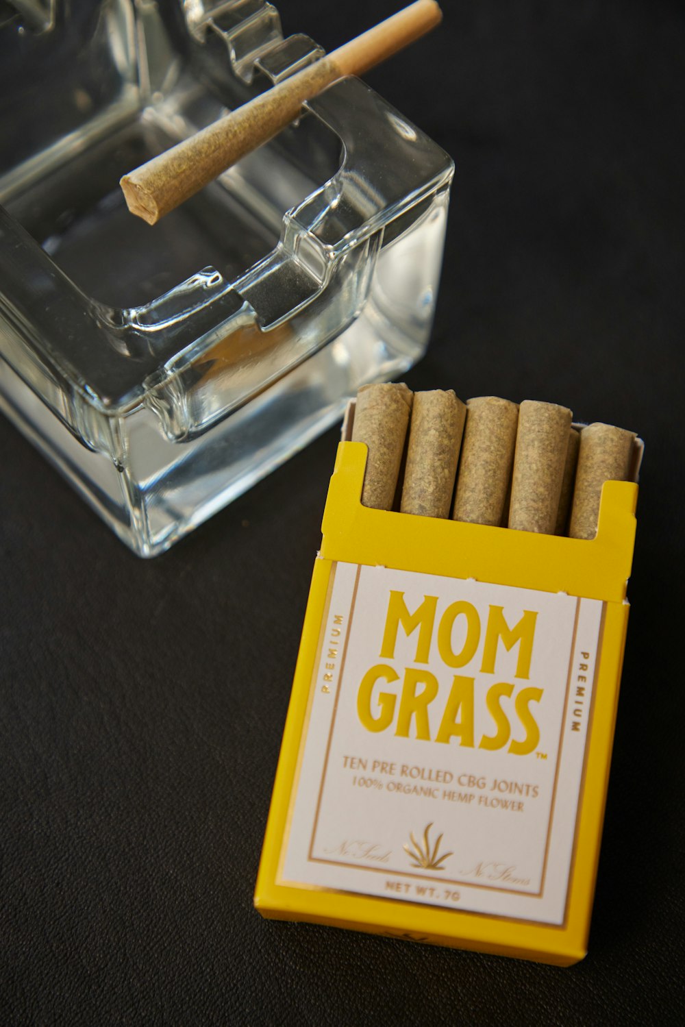 a pack of cigarettes sitting next to a box of cigarettes