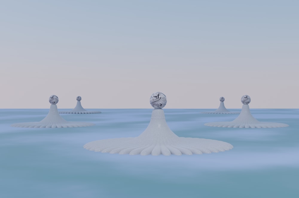a group of white objects floating on top of a body of water
