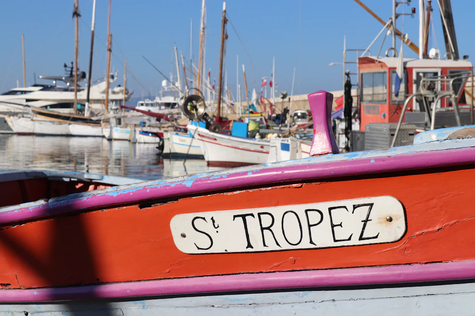 A classic wooden boat with a Saint-Tropez sign in the old harbor