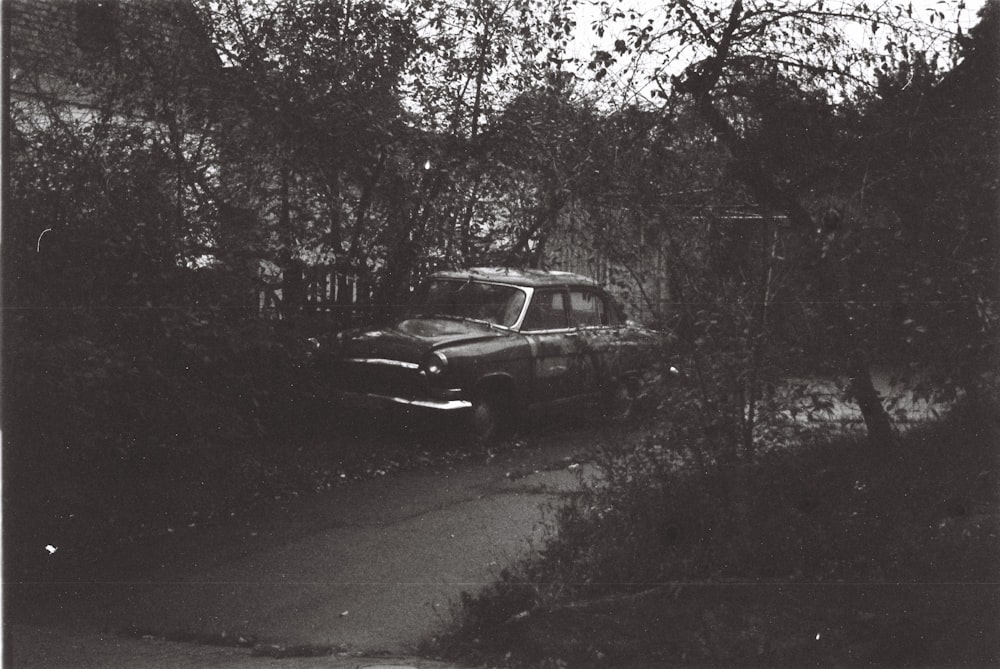 an old car parked on the side of a road