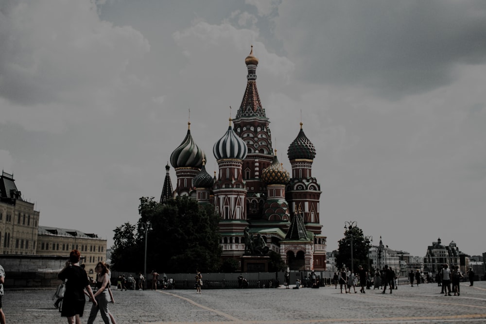 a group of people walking in front of a building