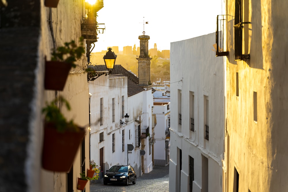 a car is parked on a narrow street