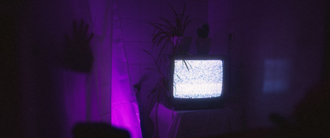 a television sitting on top of a table in a dark room