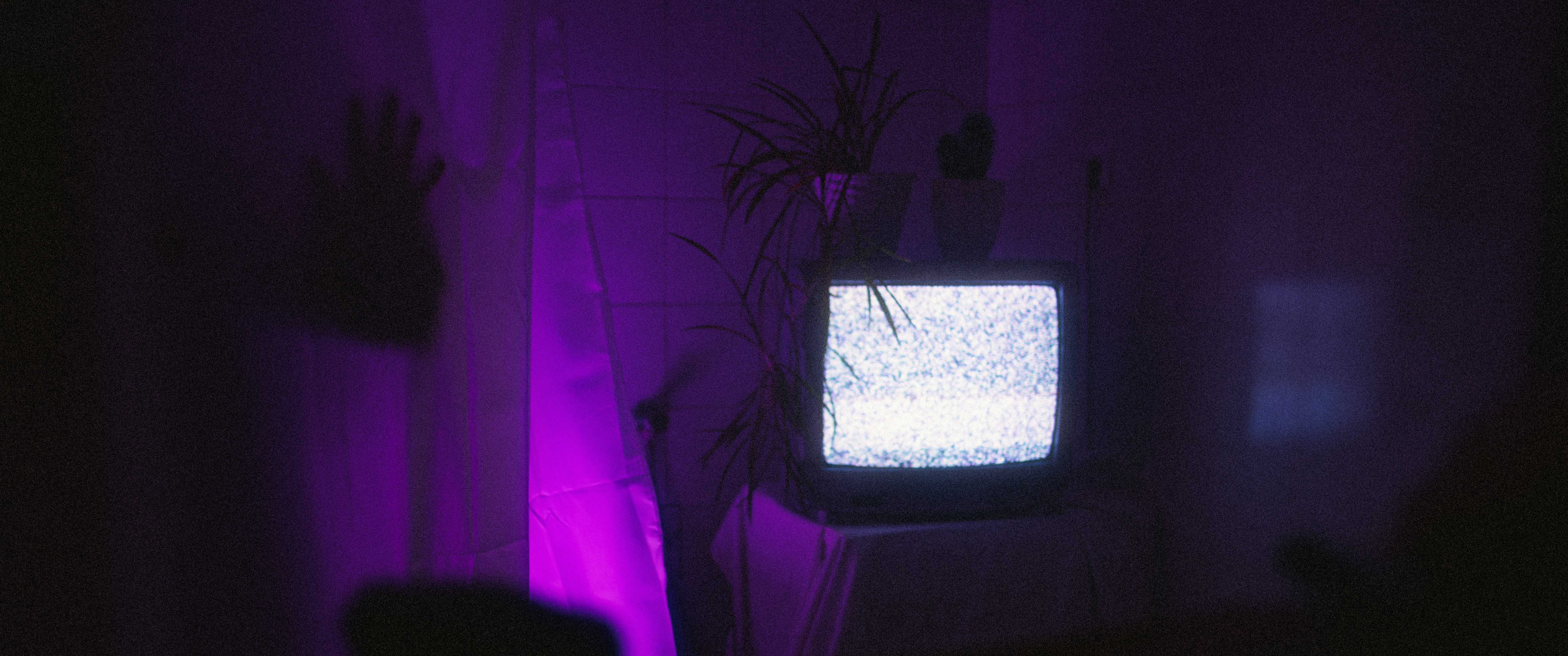 modern television displaying vibrant movie scene with color matching ambient wall backlights