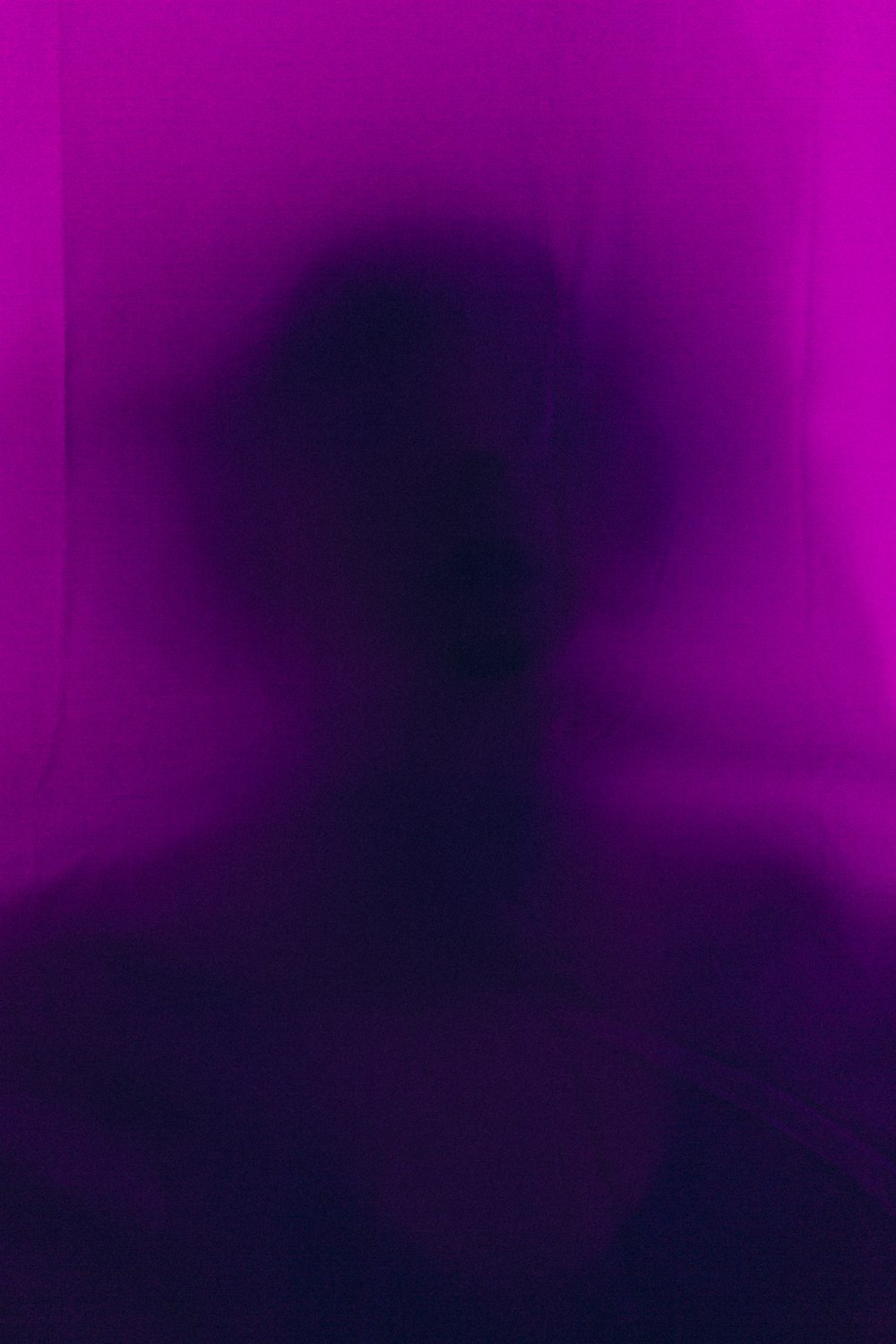 a blurry image of a person in a dark room