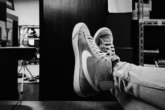A stylish office space with a desk and leather shoes.